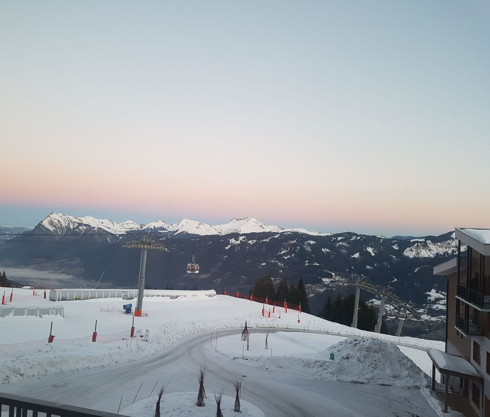 Dawn over the Grand Massif from a balcony at Club Med Grand Massif Samoëns Morillon, France, with the gondola below